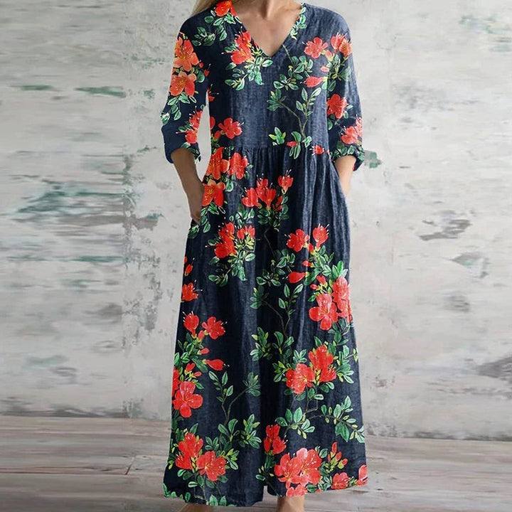 Floral maxi dress with V-neck and three-quarter sleeves, dark base with red blooms