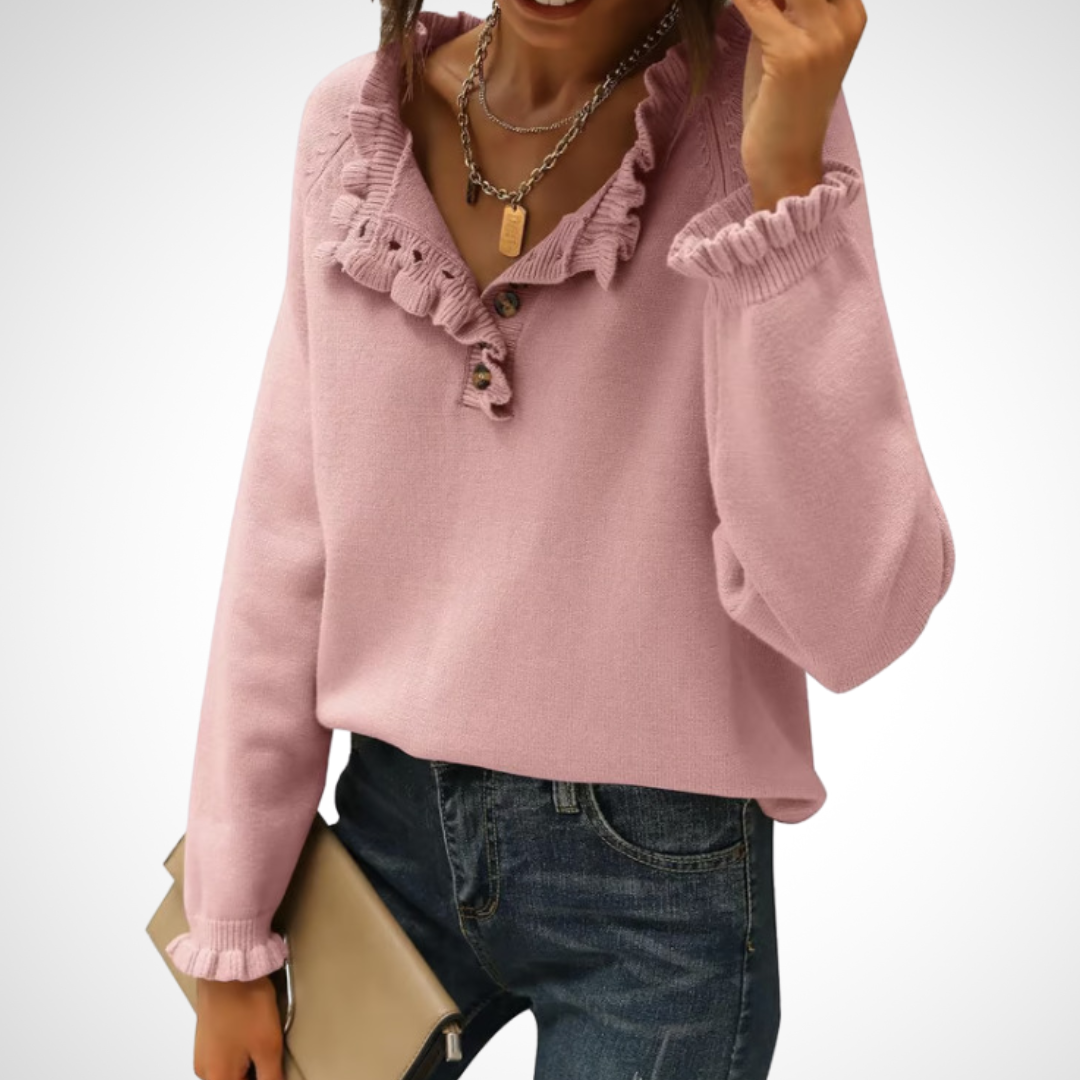 Pink long-sleeve pullover sweater with half-button placket and ruffled collar.