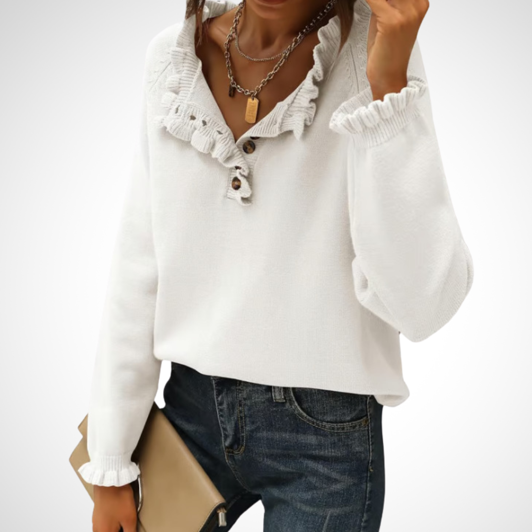 White long-sleeve pullover sweater with half-button placket and ruffled collar.