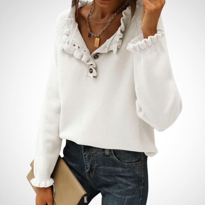 White long-sleeve pullover sweater with half-button placket and ruffled collar.