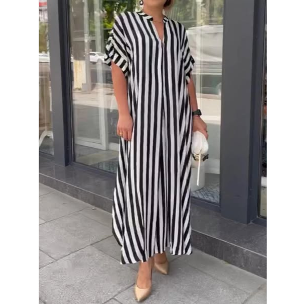 Black-and-white striped maxi dress with V-neck, short flutter sleeves, and leg slit
