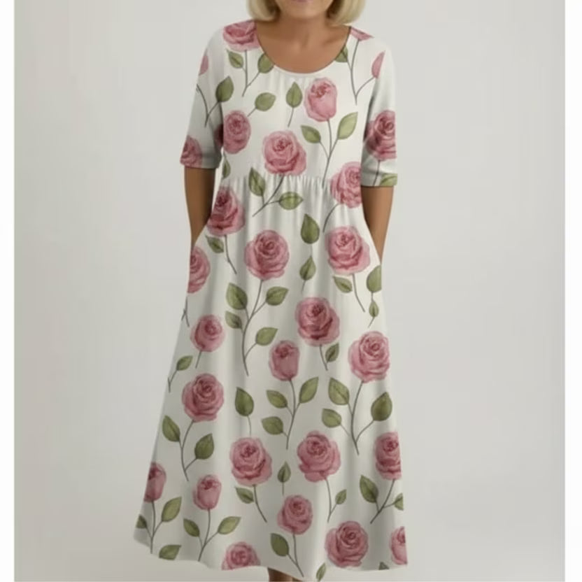 Relaxed white maxi dress with pink rose print, green leaves, short sleeves and round neck