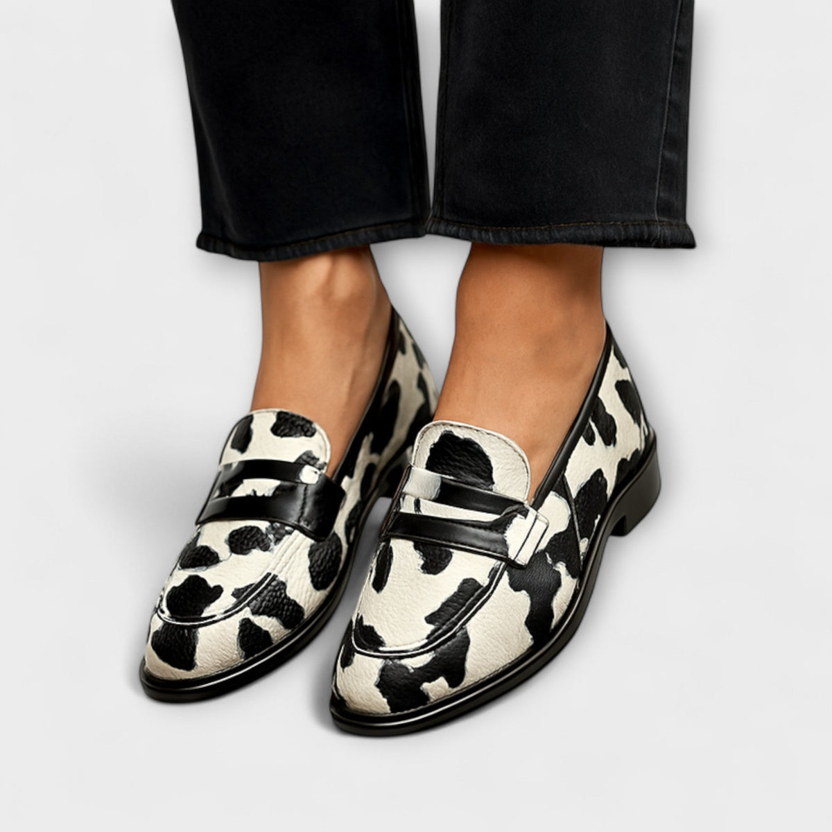 Belinda declarative loafers in black-and-white cow print with glossy black trim