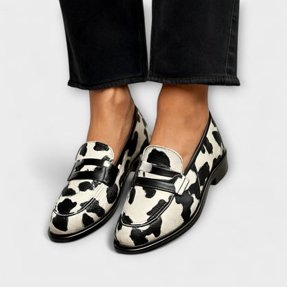 Belinda declarative loafers in black-and-white cow print with glossy black trim