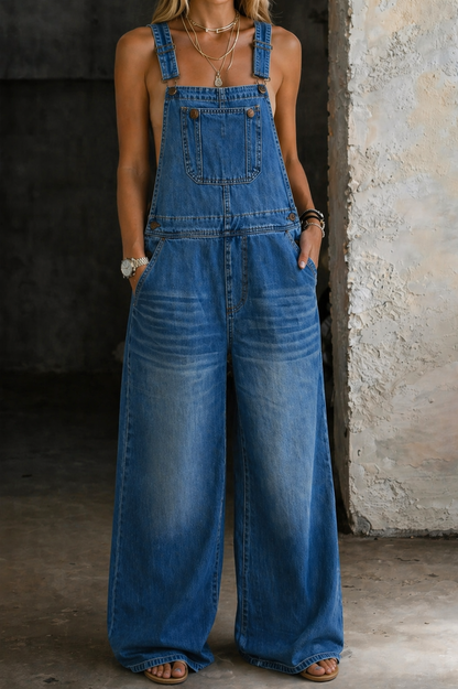 Blue sleeveless denim jumpsuit with elastic waist, front patch pockets, wide legs