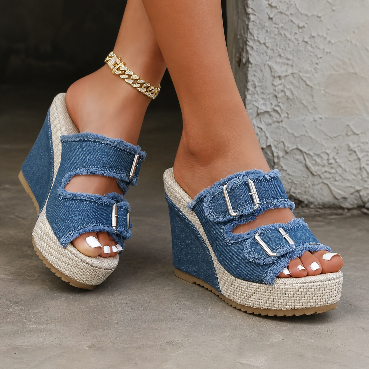 Blue denim wedge sandals with two buckle straps and open toe, textured espadrille sole