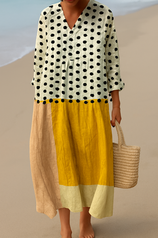 Polka sunscape dress with black dot print top and yellow tiered skirt, V-neck