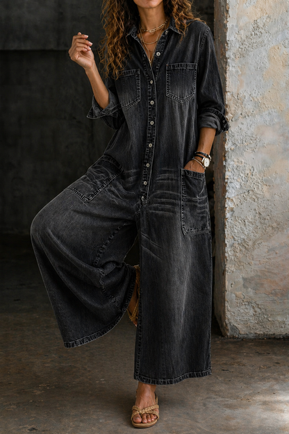 Black denim jumpsuit with button-front, chest pockets, and oversized wide-leg silhouette