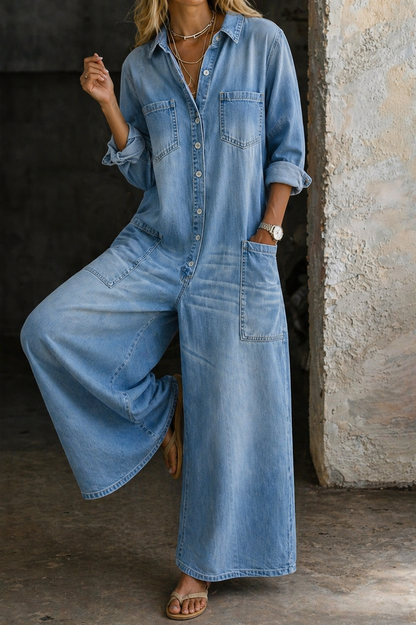 Light blue denim jumpsuit with button-front, chest pockets, and roomy wide legs