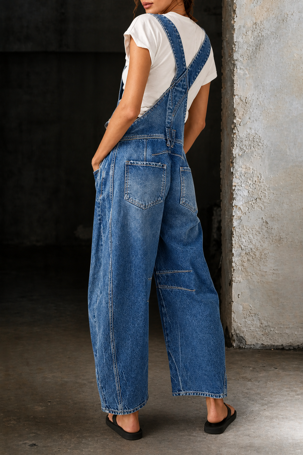 Light blue denim overalls with deep bib pocket, back patch pockets, wide straight legs.