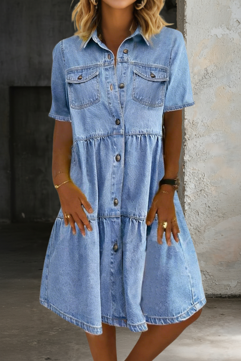 Light blue denim dress with short sleeves, button placket and tiered waist, chest pockets