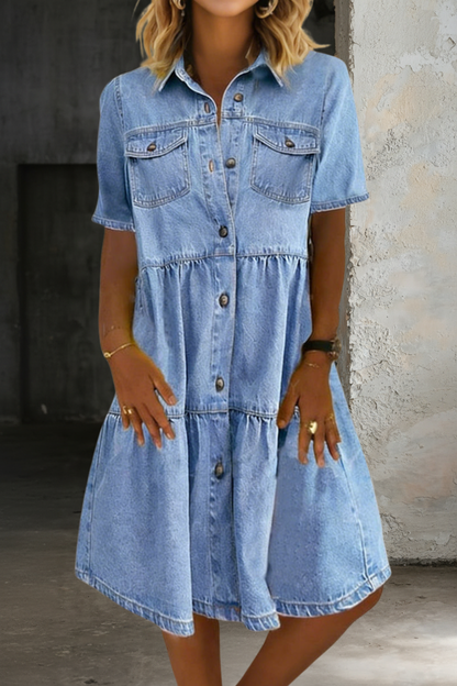 Light blue denim dress with short sleeves, button placket and tiered waist, chest pockets