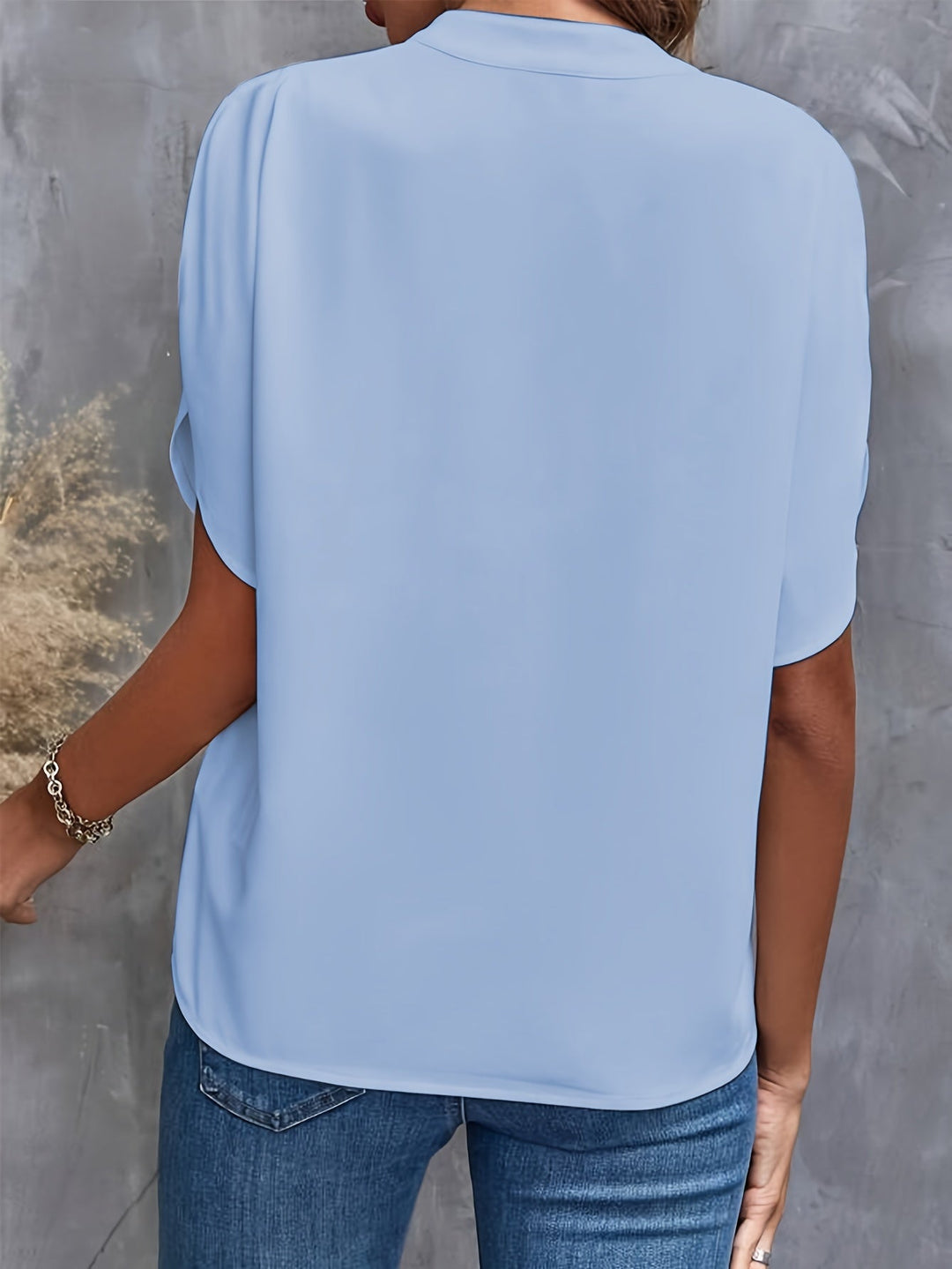 Womens luxe flared top, light blue, short sleeve back view