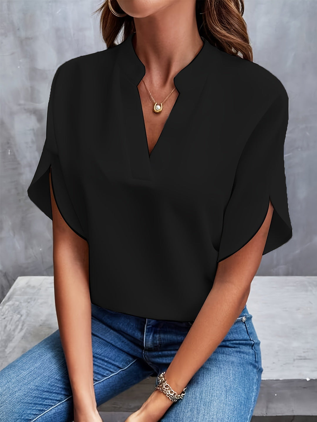 Black women’s luxe flared top with V-neck and draped short sleeves, front view