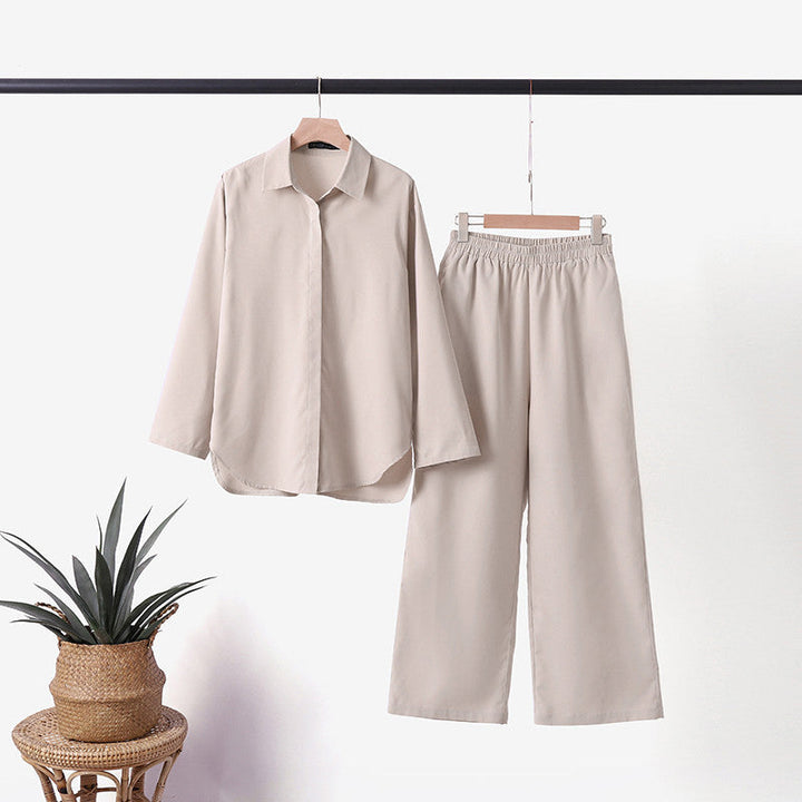 Beige two-piece set on hangers: button-up shirt with wide-leg trousers.