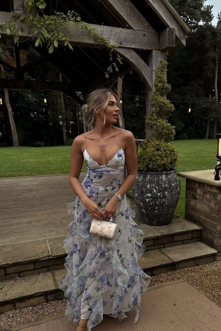 Blue floral ruffled maxi dress with spaghetti straps and tiered, layered skirt