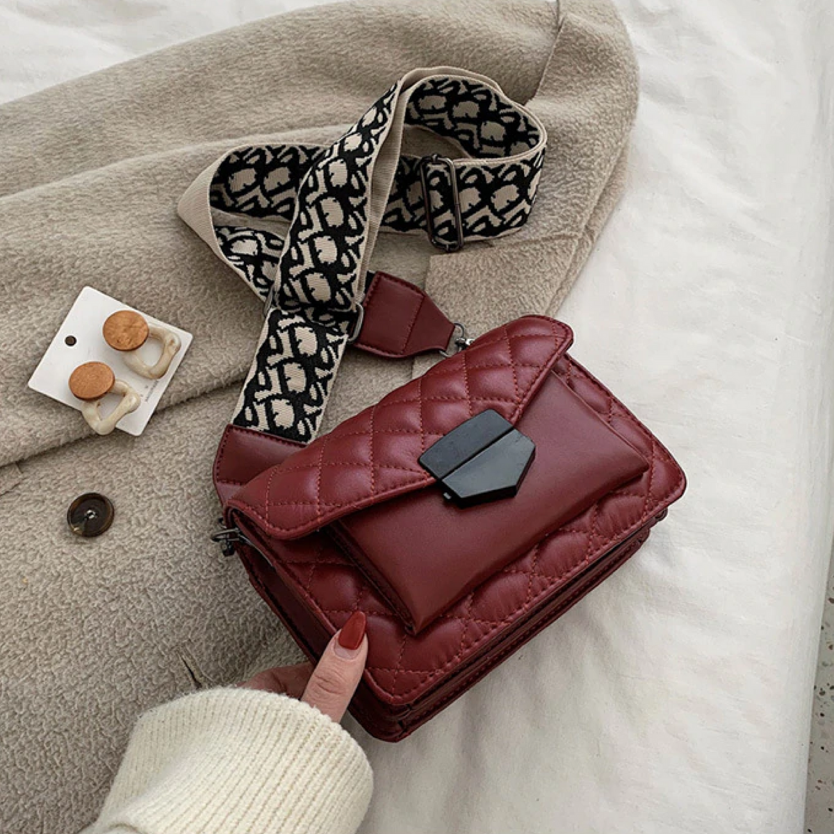 Women's luxury shoulder handbag, quilted red flap with black clasp and patterned strap