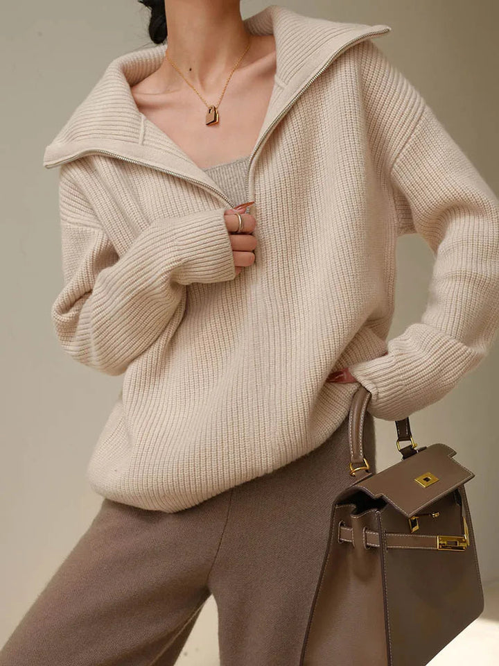 Cream knit half-zip sweater with long sleeves and ribbed collar, front zip placket