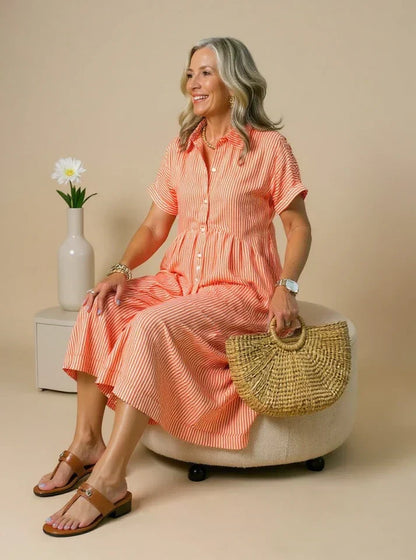 Orange striped shirt dress with short sleeves, button front, and gathered waist midi length