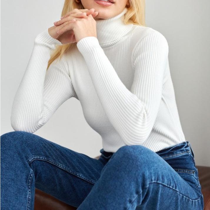 White ribbed turtleneck sweater with long sleeves and fitted knit texture
