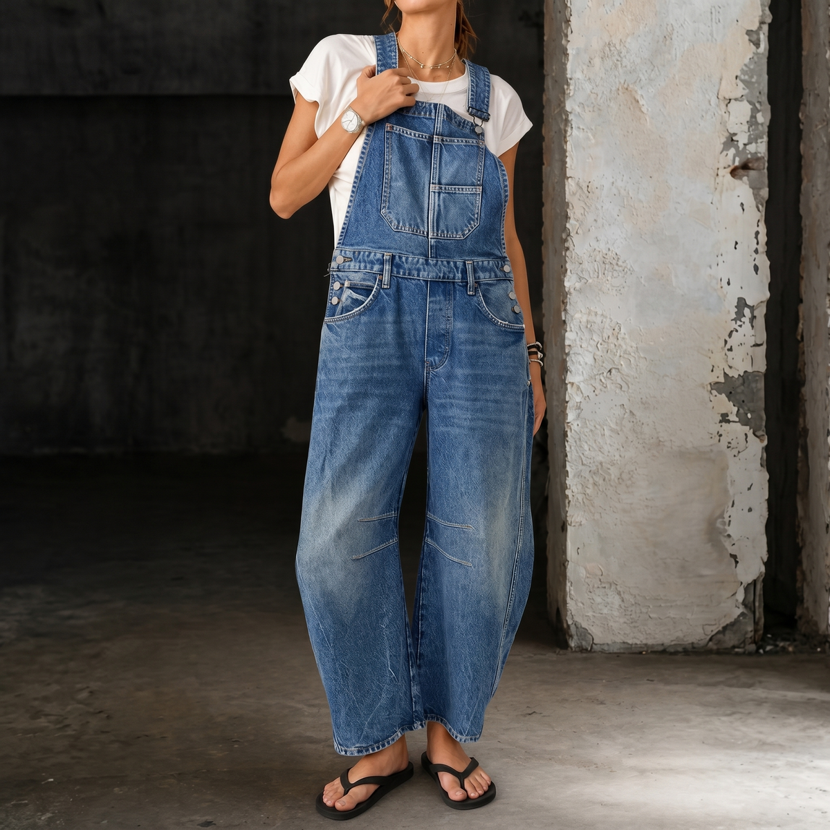 Light blue denim overalls with bib front, adjustable straps, wide legs, front pockets.