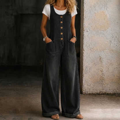 Black washed denim overalls with front bib, button straps, and side pockets