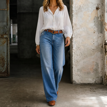 Blue high-waisted vintage jeans with straight wide-leg silhouette and belt loops.
