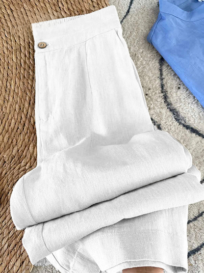 White wide-leg pants with buttoned waistband and pleats