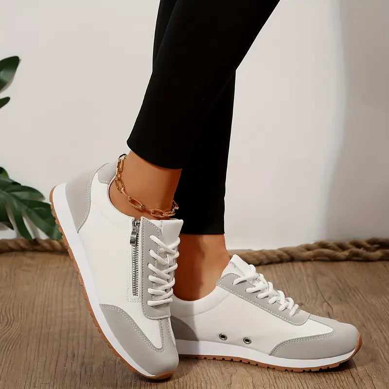 White casual sneakers, lace-up with side zipper and ankle chain.