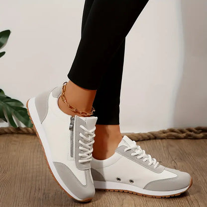 White casual sneakers, lace-up with side zipper and ankle chain.