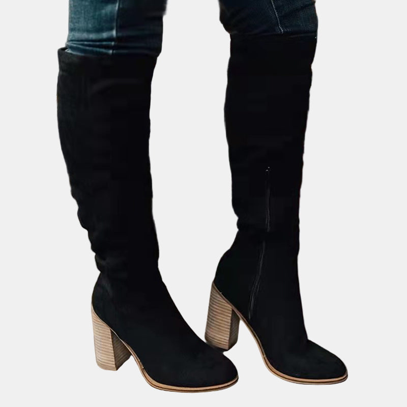Black knee-high heeled boots with stacked block heel and pointed toe