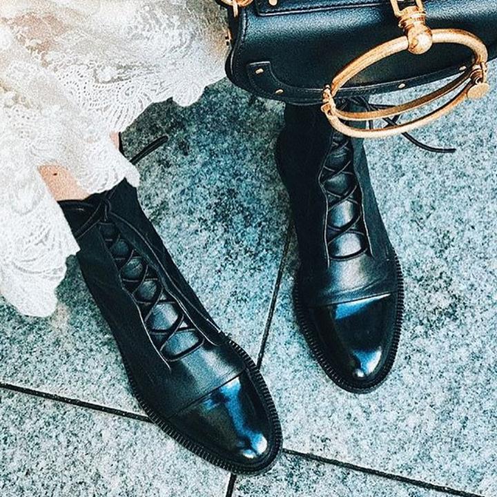 Black lace-up ankle boots with glossy finish and raised platform sole