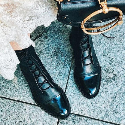Black lace-up ankle boots with glossy finish and raised platform sole