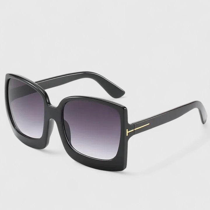 Square black sunglasses with dark gradient lenses and thin gold-toned side bar