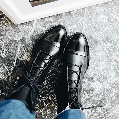 Black lace-up ankle boots with metallic sheen and padded collar