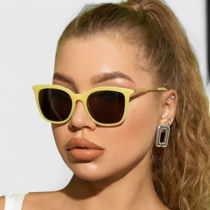 Yellow cat-eye sunglasses with dark lenses and gold-tone arms