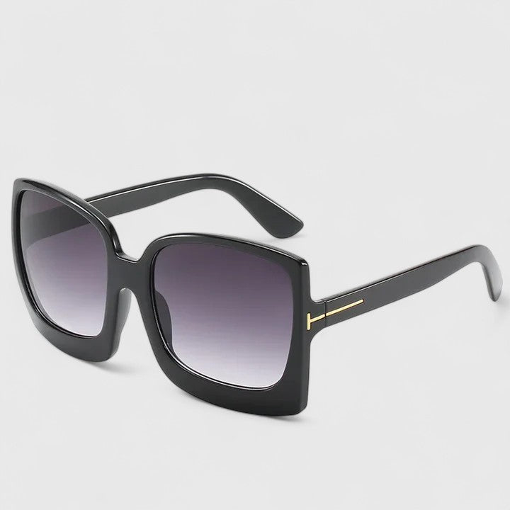 Square black sunglasses with dark gradient lenses and slim gold-toned bridge detail