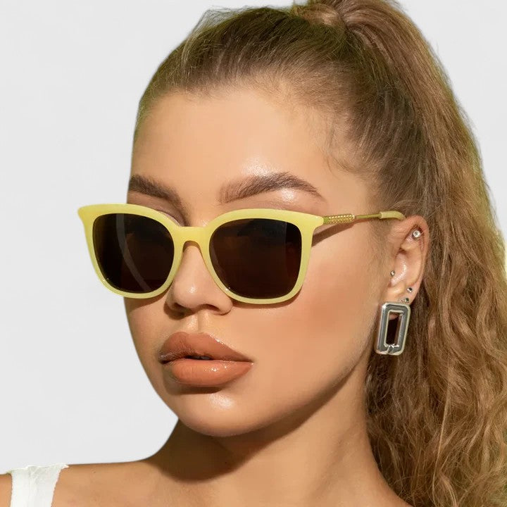 Yellow cat-eye sunglasses with dark lenses and gold-tone arms