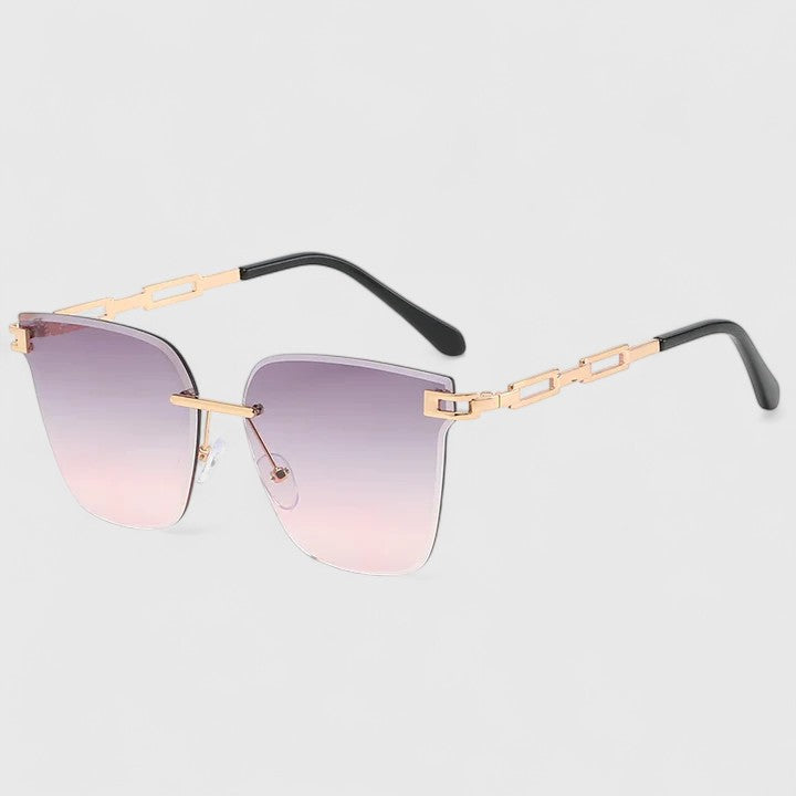 Sophisticated sunglasses with pink gradient lenses, gold frame bar, black temples