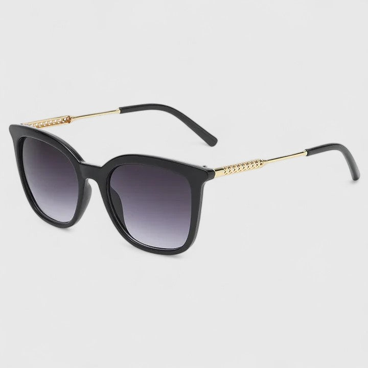 Black cat-eye sunglasses with dark gradient lenses and gold-tone hinges