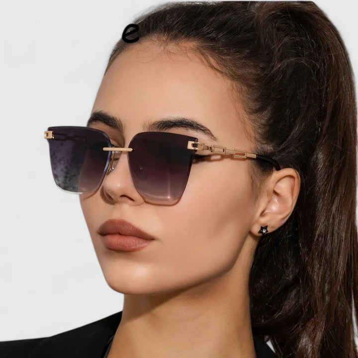 Sophisticated sunglasses with dark lenses, gold metal frame and square cat-eye shape