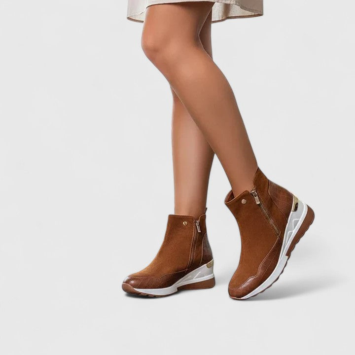 Brown orthopedic ankle boots with side zipper and cushioned white sole.