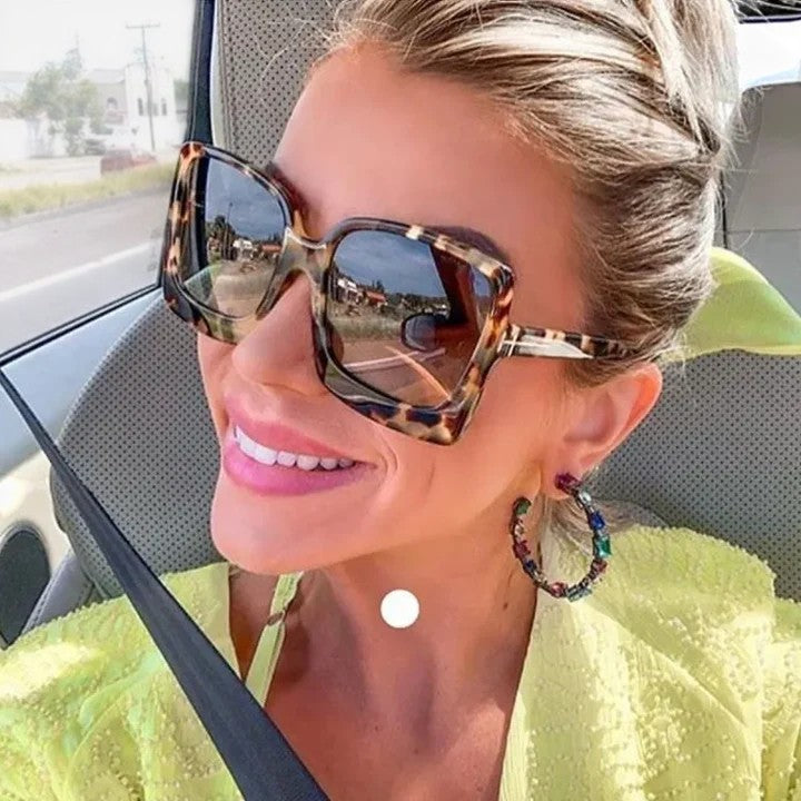 Sunglasses with dark tortoise frame and blue mirrored gradient lenses worn on face