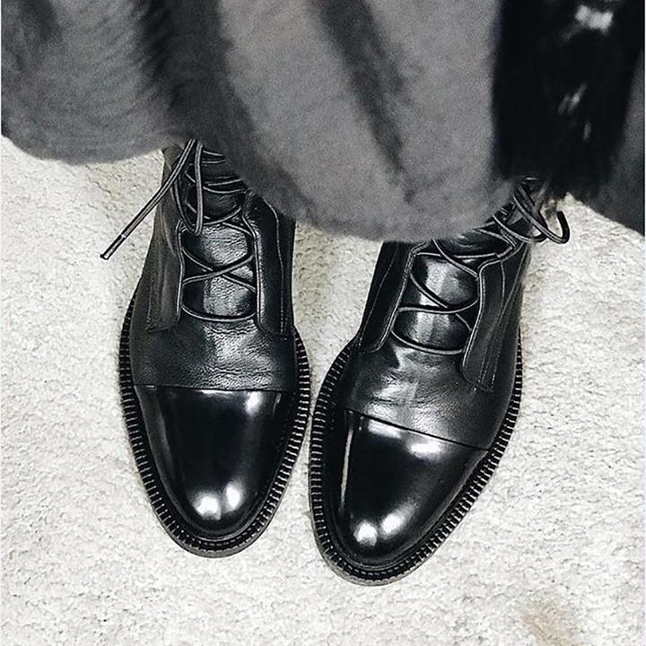 Black polished lace-up boots with thick sole and front lacing