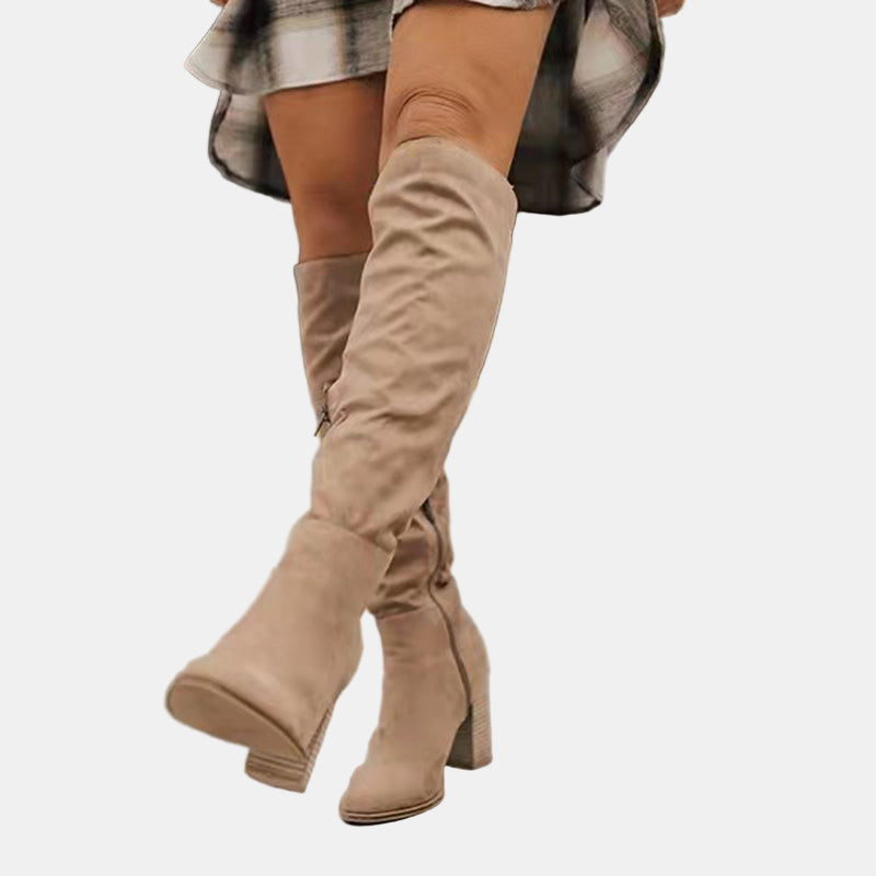 Beige slouchy heeled knee-high boots with stacked block heel and pointed toe
