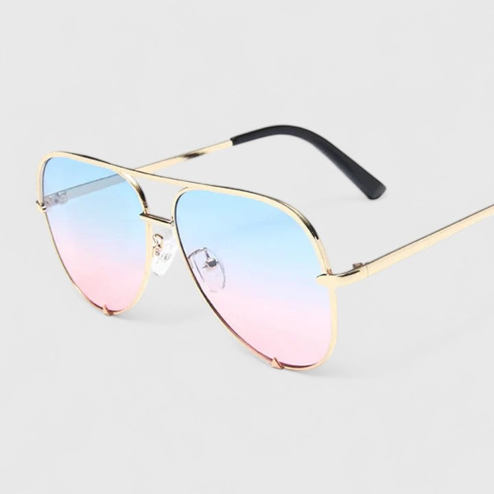 Gold sunglasses with blue-to-pink gradient lenses and slim arms