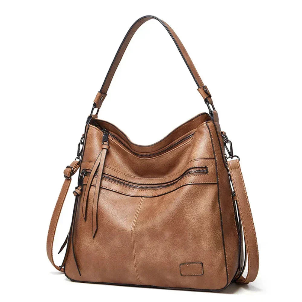 Tan hobo shoulder bag with front zip pockets and two adjustable shoulder straps