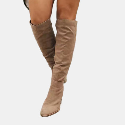Beige slouchy heeled knee-high boots with stacked block heel and pointed toe