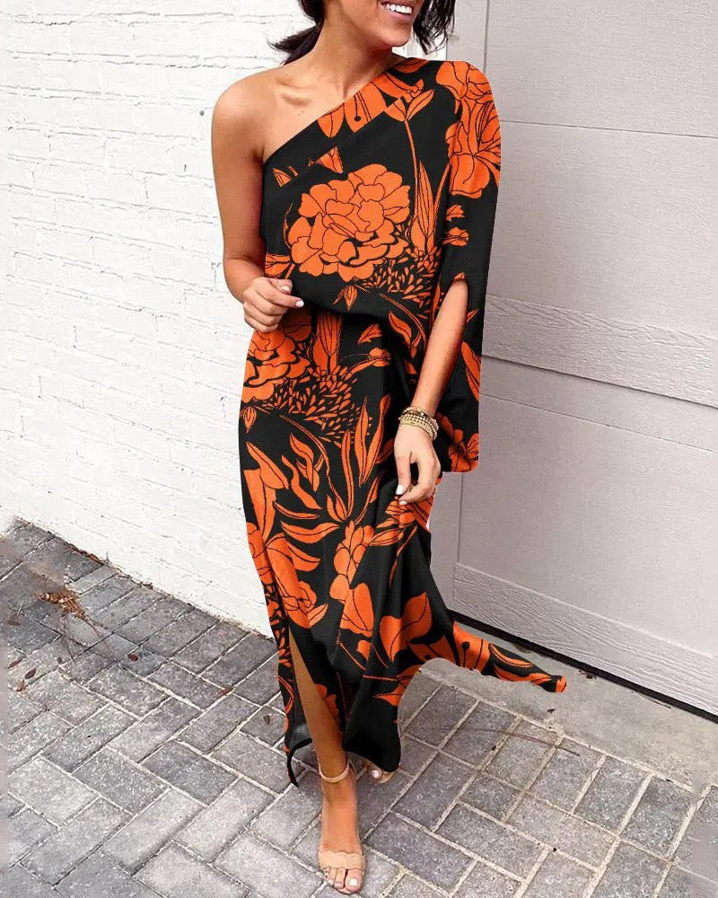 One-shoulder floral maxi dress in black with orange and red botanical print