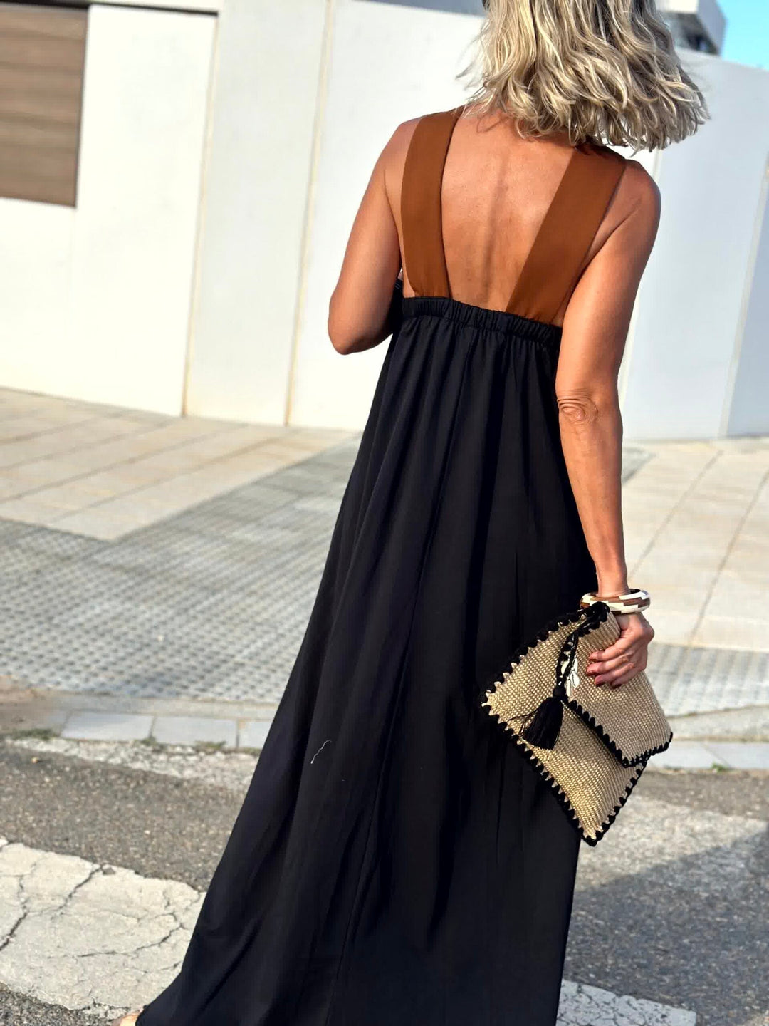 Back view: dark crossed halter maxi dress with open back and crisscross straps